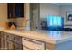 Close up of a kitchen featuring modern countertops, stainless steel appliances, and dark cabinets at 5345 E Van Buren St # 307, Phoenix, AZ 85008