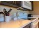 A modern kitchen featuring white marble countertops, white appliances, and dark wooden cabinetry at 5345 E Van Buren St # 307, Phoenix, AZ 85008