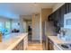 Spacious kitchen featuring stainless steel appliances, white marble countertops, and dark cabinets at 5345 E Van Buren St # 307, Phoenix, AZ 85008