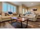 Cozy living room featuring hardwood flooring and plush seating with colorful accents at 5345 E Van Buren St # 307, Phoenix, AZ 85008