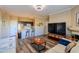 Open-concept living area with modern decor, a large TV, and a view of the kitchen at 5345 E Van Buren St # 307, Phoenix, AZ 85008