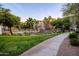 Scenic pond surrounded by lush landscaping, palm trees, and well-maintained apartment buildings at 5345 E Van Buren St # 307, Phoenix, AZ 85008