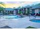 Sparkling pool and hot tub with comfortable lounge chairs and lush landscaping at sunset at 5345 E Van Buren St # 307, Phoenix, AZ 85008