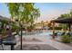 Community pool area with BBQ grill, lounge chairs and beautiful landscaping at 5345 E Van Buren St # 307, Phoenix, AZ 85008