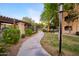 Picturesque walkway winding through landscaped grounds with mature trees and lush greenery at 5345 E Van Buren St # 307, Phoenix, AZ 85008