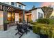Inviting back patio at dusk with a fire pit, pergola and stylish Adirondack chairs at 5929 E Indian School Rd, Phoenix, AZ 85018