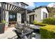 Inviting back patio with a fire pit, pergola and stylish Adirondack chairs. Beautiful landscaping at 5929 E Indian School Rd, Phoenix, AZ 85018