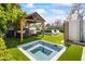Beautiful backyard featuring an outdoor pavilion, spa, and in-ground pool on a manicured lawn at 5929 E Indian School Rd, Phoenix, AZ 85018