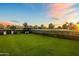 Serene backyard featuring a manicured lawn, gazebo, and picturesque views of the adjacent golf course at 5929 E Indian School Rd, Phoenix, AZ 85018