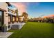 Extensive backyard featuring a hot tub, lush lawn, and charming outdoor seating area, ideal for entertaining at 5929 E Indian School Rd, Phoenix, AZ 85018