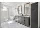 Clean, elegant bathroom with marble floors, glass shower, soaking tub and dual vanity at 5929 E Indian School Rd, Phoenix, AZ 85018