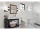 The bathroom features a frameless shower, stand alone sink and marble tile floors at 5929 E Indian School Rd, Phoenix, AZ 85018