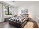 This modern bedroom features hard wood floors, natural lighting and calming paint at 5929 E Indian School Rd, Phoenix, AZ 85018