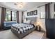 This bedroom offers neutral walls, plush carpet, and unique lighting creating a cozy and inviting atmosphere at 5929 E Indian School Rd, Phoenix, AZ 85018