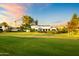 Stunning home featuring a well-manicured lawn, mature trees, and expansive grounds at 5929 E Indian School Rd, Phoenix, AZ 85018