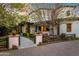 Beautiful home at dusk with mature trees, manicured landscaping and a private courtyard at 5929 E Indian School Rd, Phoenix, AZ 85018