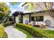 Charming home with a manicured front yard and inviting patio seating area at 5929 E Indian School Rd, Phoenix, AZ 85018