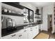 Modern kitchen with white cabinets, dark countertops, stainless appliances, and minimalist design at 5929 E Indian School Rd, Phoenix, AZ 85018