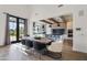 Well-lit kitchen area with modern appliances, a dining table, and an open layout leading outdoors at 5929 E Indian School Rd, Phoenix, AZ 85018