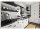 Well-appointed kitchen with white cabinetry, sleek countertops, modern appliances, and ample natural light at 5929 E Indian School Rd, Phoenix, AZ 85018