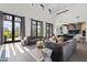 Bright living room with high ceilings, large windows, comfortable seating, and seamless indoor/outdoor flow at 5929 E Indian School Rd, Phoenix, AZ 85018