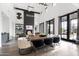 Open living and dining area with a fireplace, high ceilings, modern decor, and abundant natural light at 5929 E Indian School Rd, Phoenix, AZ 85018