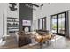 Spacious living room boasts a high ceiling, fireplace, modern decor, and access to the outdoors at 5929 E Indian School Rd, Phoenix, AZ 85018