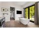 Elegant bathroom featuring a soaking tub, modern fixtures, and an outdoor view at 5929 E Indian School Rd, Phoenix, AZ 85018
