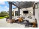 Inviting outdoor living area with lounge seating and large-screen TV under a stylish pergola at 5929 E Indian School Rd, Phoenix, AZ 85018