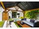 Well-appointed patio with modern furniture, adjacent to a serene spa and lush garden at 5929 E Indian School Rd, Phoenix, AZ 85018