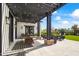 Covered patio with ample seating, a custom ping pong table and stylish outdoor decor at 5929 E Indian School Rd, Phoenix, AZ 85018