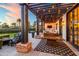Outdoor living space with warm lighting, outdoor furniture and a fire pit at 5929 E Indian School Rd, Phoenix, AZ 85018