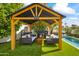 Relaxing backyard pavilion with comfortable seating, a mini-bar and a pool nearby at 5929 E Indian School Rd, Phoenix, AZ 85018