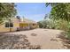 Landscaped backyard featuring a covered patio and flowering shrubs, ideal for outdoor activities at 6102 E Inglewood St, Mesa, AZ 85205