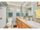 Well-lit bathroom featuring a shower, vanity, and neutral green color palette at 6102 E Inglewood St, Mesa, AZ 85205