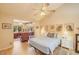 Comfortable bedroom featuring hardwood floors, a ceiling fan, and an attached sitting area for relaxation at 6102 E Inglewood St, Mesa, AZ 85205