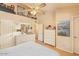 Inviting bedroom featuring hardwood floors, a ceiling fan, and ample natural light, creating a cozy retreat at 6102 E Inglewood St, Mesa, AZ 85205