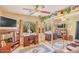 Bright bedroom featuring hardwood floors, a ceiling fan, and a mirrored closet adding depth and style at 6102 E Inglewood St, Mesa, AZ 85205