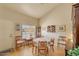 Charming dining area with a round table, complemented by a window with lace curtains at 6102 E Inglewood St, Mesa, AZ 85205