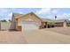 Single-story home featuring a two-car garage, brick accents, and well-maintained landscaping at 6102 E Inglewood St, Mesa, AZ 85205