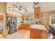 Well-lit kitchen features wood cabinets, stainless steel appliances, and a window overlooking outdoor greenery at 6102 E Inglewood St, Mesa, AZ 85205
