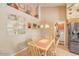 Bright eat-in kitchen featuring stainless steel appliances and a dining table with seating for four at 6102 E Inglewood St, Mesa, AZ 85205
