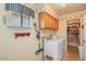Convenient laundry room with a washer, dryer, built-in shelving and storage space for efficient household tasks at 6102 E Inglewood St, Mesa, AZ 85205