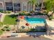 Aerial view of the community pool, spa, landscaping, and nearby residential buildings at 7021 E Earll Dr # 204, Scottsdale, AZ 85251