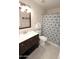 Bathroom with modern vanity, framed mirror, and shower with a decorative patterned curtain at 7021 E Earll Dr # 204, Scottsdale, AZ 85251