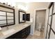 Bathroom with double sinks, granite counters, dark cabinetry, and separate toilet and shower rooms at 7021 E Earll Dr # 204, Scottsdale, AZ 85251