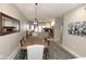 Elegant dining room with stylish lighting, a modern rug, and an open view to the living room at 7021 E Earll Dr # 204, Scottsdale, AZ 85251