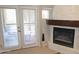 Close-up of the fireplace with a view to the patio from double doors at 7021 E Earll Dr # 204, Scottsdale, AZ 85251