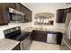 Well-appointed kitchen featuring stainless steel appliances, granite countertops, and dark wood cabinets at 7021 E Earll Dr # 204, Scottsdale, AZ 85251