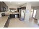 Modern kitchen with stainless steel appliances, granite countertops, and dark wood cabinetry at 7021 E Earll Dr # 204, Scottsdale, AZ 85251